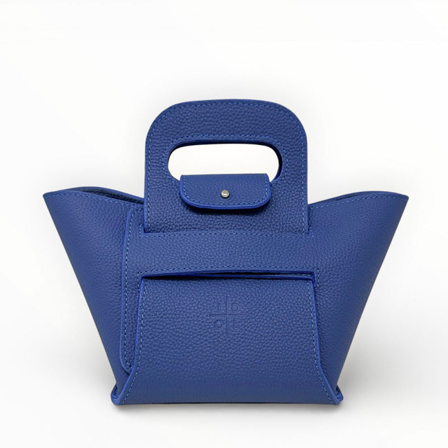 Blue handbag with a unique handle design on a white background