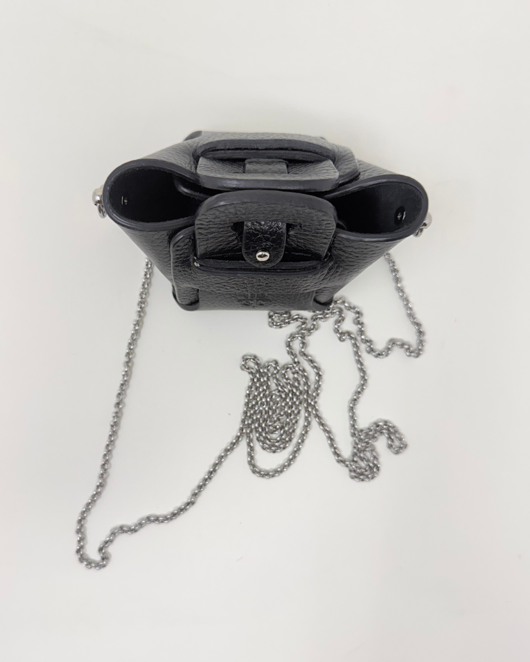 Black Micro handbag with a chain detail on a white background